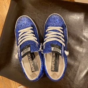 Golden Goose blue sparkly low-star sneakers.